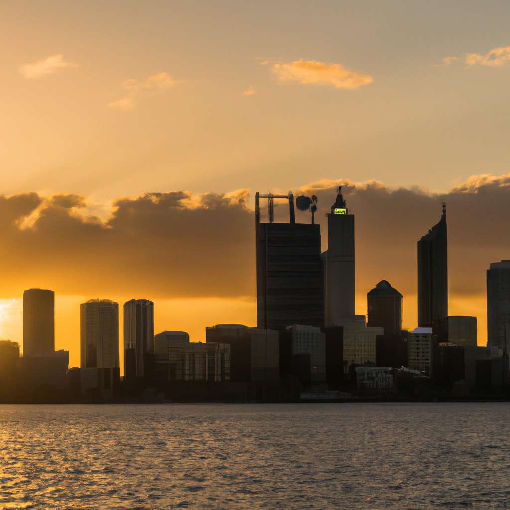 Sunset reflecting on Perth city skyline with golden hues and water ripples.