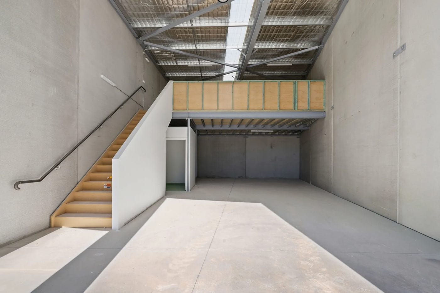 Interior of a Hume warehouse unit showing the mezzanine level and internal staircase