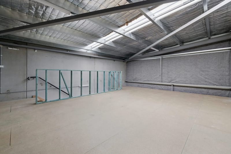 Warehouse interior with mezzanine framing and high clearance